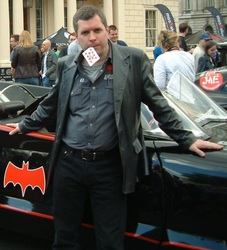 Man leaning on Batmobile