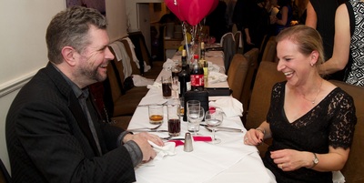 Two people at a table laughing